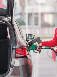 close up of a person refueling the car at a gas station